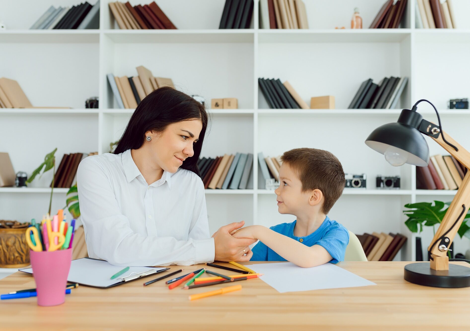 Child psychologist attending small boy. The concept of psychological assistance to children.