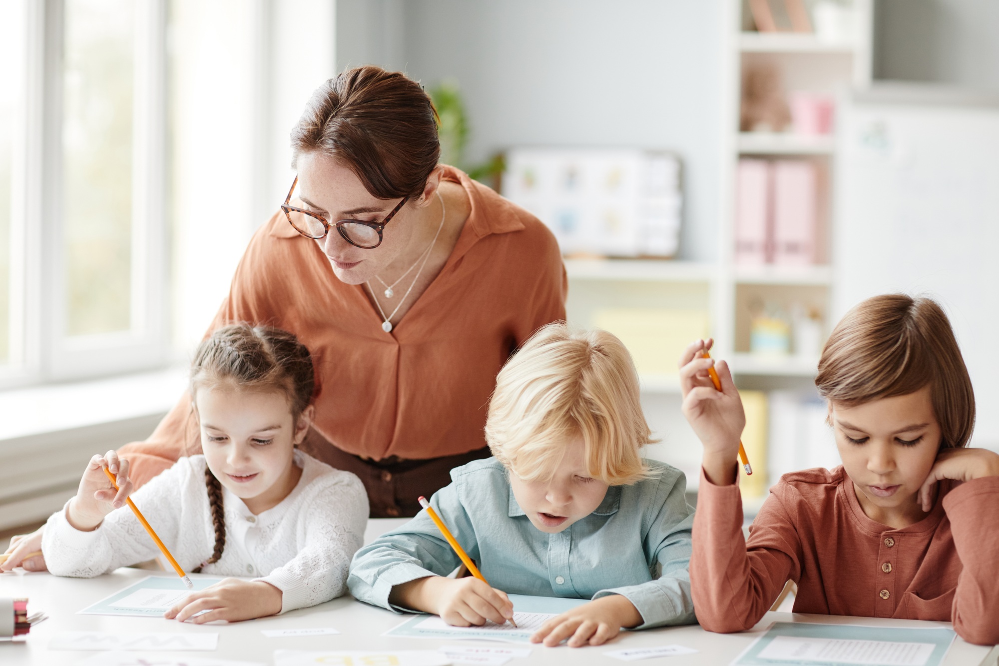 Teacher teaching children at school